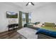 Bright bedroom features two twin beds, large window, and a flat screen tv for comfortable, modern living at 9741 Taylor River Cir, Littleton, CO 80125