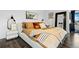 Modern bedroom featuring hardwood floors, stylish decor, and comfortable bed with decorative pillows and wall art at 9741 Taylor River Cir, Littleton, CO 80125