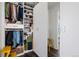 Spacious closet with ample storage and hanging space, featuring built-in shelving and a yellow stool at 9741 Taylor River Cir, Littleton, CO 80125