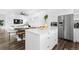 Open concept kitchen with stainless steel appliances, large island and adjacent dining area at 9741 Taylor River Cir, Littleton, CO 80125