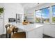 Bright kitchen features stainless steel appliances, island with seating, and ample storage space at 9741 Taylor River Cir, Littleton, CO 80125
