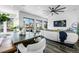 Open-concept living area with seamless flow to the outdoor patio, sofa, and a large dining table at 9741 Taylor River Cir, Littleton, CO 80125
