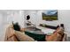 Comfortable living room with leather seating, stylish decor, and a large screen TV for entertainment at 9741 Taylor River Cir, Littleton, CO 80125