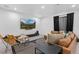 Stylish living room with leather seating, modern rug, and a large screen TV for entertainment at 9741 Taylor River Cir, Littleton, CO 80125