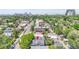 Aerial view of a home with solar panels on the roof, surrounded by lush greenery and a vibrant cityscape at 444 S Pearl St, Denver, CO 80209