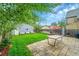 Well-maintained backyard with a blue shed, green lawn, and patio, perfect for outdoor enjoyment and relaxation at 444 S Pearl St, Denver, CO 80209