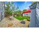 Charming backyard featuring a stone patio, grassy area, and shade for outdoor living and dining at 444 S Pearl St, Denver, CO 80209