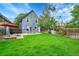 Spacious backyard with a green lawn and stone patio provides ample room for recreation and entertaining at 444 S Pearl St, Denver, CO 80209