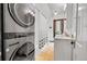 Bathroom featuring a stacked washer/dryer, updated vanity and tiled floors at 444 S Pearl St, Denver, CO 80209