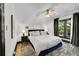 Well-lit bedroom boasts soft carpet, a ceiling fan, and large windows with natural light at 444 S Pearl St, Denver, CO 80209