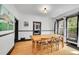 Bright dining room featuring hardwood floors, light-colored walls, and a classic wooden table with seating for six at 444 S Pearl St, Denver, CO 80209