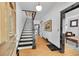 Elegant entryway showcasing a staircase with black and white accents, hardwood floors, and stylish decor at 444 S Pearl St, Denver, CO 80209