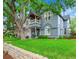 Charming two-story home with a well-manicured lawn and mature trees, providing curb appeal at 444 S Pearl St, Denver, CO 80209