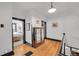 Hallway with wood floors, black trim, and a view of a bedroom at 444 S Pearl St, Denver, CO 80209