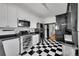 Contemporary kitchen with black and white checkered flooring, stainless steel appliances and white cabinetry at 444 S Pearl St, Denver, CO 80209