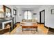 Cozy living room featuring a fireplace, hardwood floors, a large window, and stylish furniture at 444 S Pearl St, Denver, CO 80209