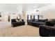 Spacious basement rec room, plush seating, and projector at 9965 E 143Rd Way, Brighton, CO 80602