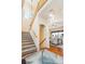 Elegant entryway with hardwood floors, a grand staircase, and stylish light fixtures at 9965 E 143Rd Way, Brighton, CO 80602