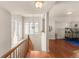 Upstairs hallway with hardwood floors and a birdcage at 9965 E 143Rd Way, Brighton, CO 80602