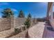Backyard features a stone wall, patio, and landscaping, creating a peaceful outdoor retreat with privacy and charm at 12732 Fisher Dr, Englewood, CO 80112