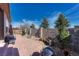 Beautiful backyard with a stone wall, patio, and landscaping, creating a private and serene outdoor oasis at 12732 Fisher Dr, Englewood, CO 80112