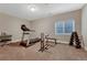 Workout room with treadmill, weight bench, and natural light, providing a dedicated space for fitness and wellness at 12732 Fisher Dr, Englewood, CO 80112