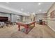 Finished basement game room with pool table, TV, bar area and neutral carpet at 12732 Fisher Dr, Englewood, CO 80112
