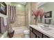 Bathroom featuring decorative tile work in the shower, and vanity with marble countertop at 12732 Fisher Dr, Englewood, CO 80112
