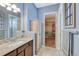 Bathroom with vanity, granite countertops and a walk-in closet with custom shelving at 12732 Fisher Dr, Englewood, CO 80112