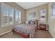 Bedroom with a queen bed, neutral walls, and large windows with plantation shutters at 12732 Fisher Dr, Englewood, CO 80112