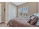 Bedroom with a queen bed, neutral walls, and large windows with plantation shutters at 12732 Fisher Dr, Englewood, CO 80112