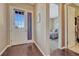 Welcoming entryway featuring hardwood floors, natural light, and views into the bedroom at 12732 Fisher Dr, Englewood, CO 80112