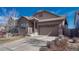 Inviting curb appeal with a two-car garage and stone accents at 12732 Fisher Dr, Englewood, CO 80112
