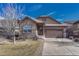 Charming home with stone accents, a two-car garage, and a well-maintained front yard at 12732 Fisher Dr, Englewood, CO 80112