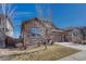 Charming home showcasing stone accents, a well-kept lawn, and a spacious two-car garage at 12732 Fisher Dr, Englewood, CO 80112