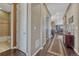 Hallway with hardwood flooring, leading past a bathroom and into the living areas at 12732 Fisher Dr, Englewood, CO 80112