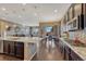 Bright kitchen featuring granite counters and dark wood cabinets with stainless appliances at 12732 Fisher Dr, Englewood, CO 80112