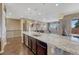 Kitchen island with dishwasher, sink and stainless steel appliances, with bar stool seating at 12732 Fisher Dr, Englewood, CO 80112
