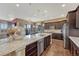 Spacious kitchen with a center island, stainless appliances, and open flow into the dining area at 12732 Fisher Dr, Englewood, CO 80112