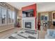 Living room featuring fireplace, TV, and view into adjacent dining and kitchen areas at 12732 Fisher Dr, Englewood, CO 80112