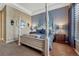 Spacious bedroom with four-poster bed, neutral decor, and ample natural light at 12732 Fisher Dr, Englewood, CO 80112