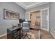Office with French doors, a large desk, two monitors and neutral colored carpet at 12732 Fisher Dr, Englewood, CO 80112