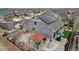 An aerial view of the home with a landscaped backyard, featuring a gazebo, and solar panels on the roof at 5519 Genoa St, Denver, CO 80249