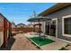 Backyard featuring a dining area with outdoor kitchen and rock landscaping with decorative stones at 5519 Genoa St, Denver, CO 80249