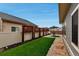 Well-maintained backyard with artificial turf, decorative privacy screens, and stone pavers for outdoor dining at 5519 Genoa St, Denver, CO 80249