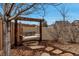 Charming backyard swing set hanging from a wooden frame with mature trees, creating a relaxing outdoor space at 5519 Genoa St, Denver, CO 80249