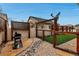 Backyard featuring decorative screens, a built-in dog run, stone pavers, and outdoor cooking space at 5519 Genoa St, Denver, CO 80249