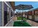 Comfortable patio area with table, chairs, patio umbrella, stone pavers, and decorative rock features at 5519 Genoa St, Denver, CO 80249