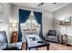 Well-lit bedroom featuring a comfortable chair, a ceiling fan, and a desk area for work or study at 5519 Genoa St, Denver, CO 80249