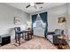 Comfortable bedroom featuring a ceiling fan, a cozy chair, and a well-lit desk area at 5519 Genoa St, Denver, CO 80249
